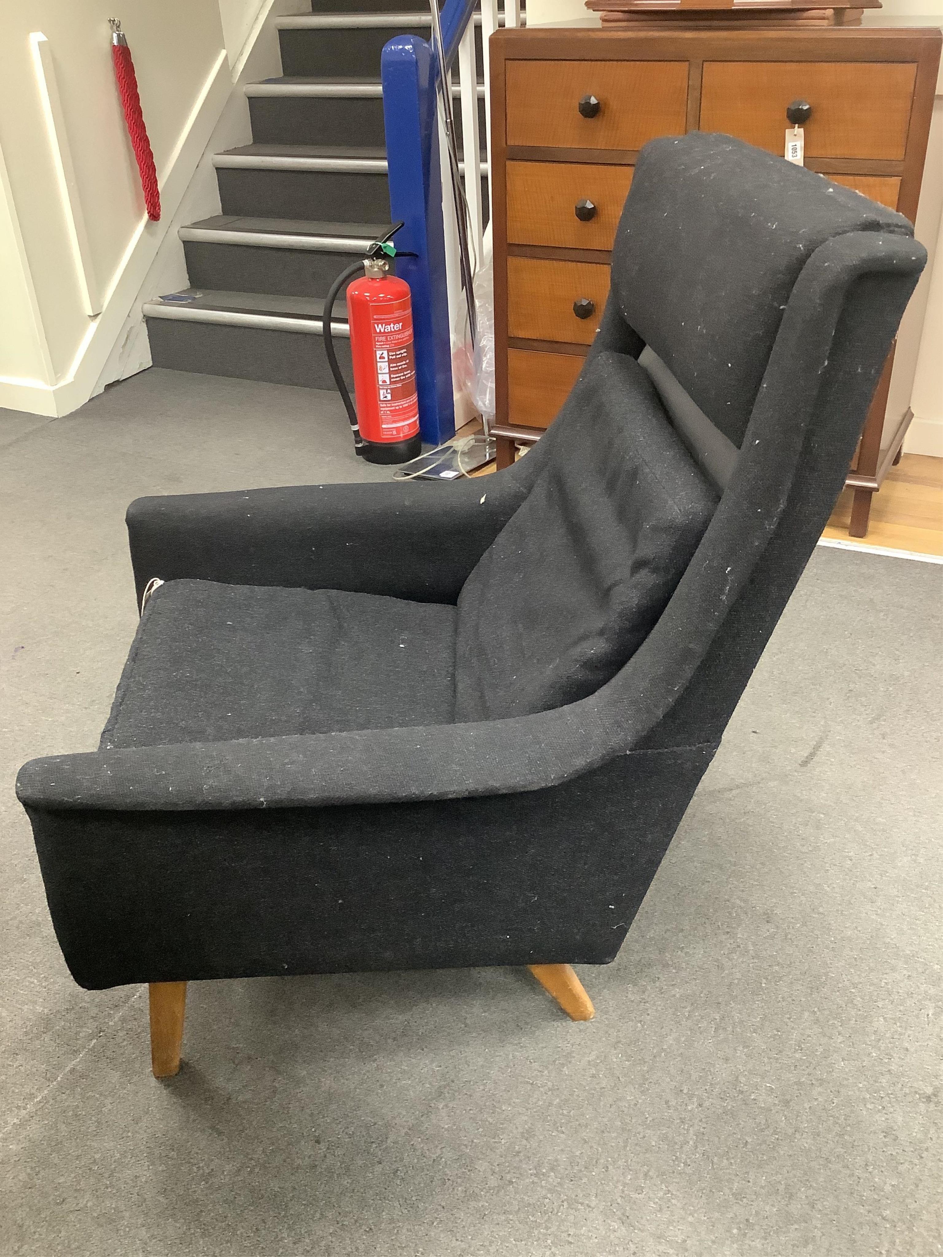 In the manner of Fritz Hansen, a mid century black fabric high back lounge chair, width 76cm, depth 74cm, height 94cm. Condition - fair